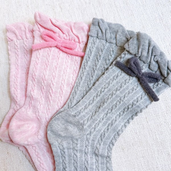 Flat lay of pink and grey Yarn Bow Socks set showing soft bow embellishments.