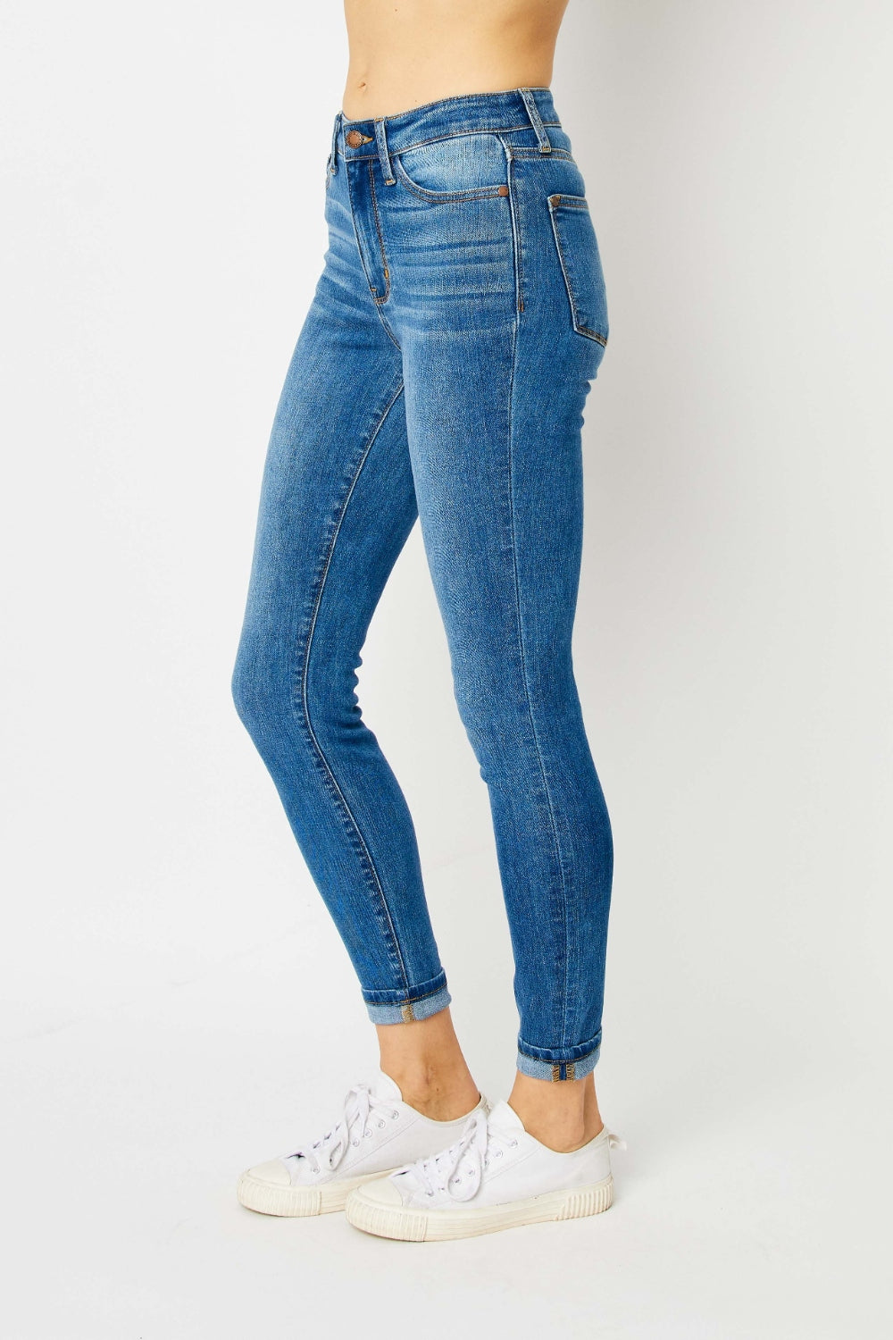 Mid-rise skinny jeans with cuffed hems and a zip fly. Medium wash with a slim fit and highly stretchy fabric.