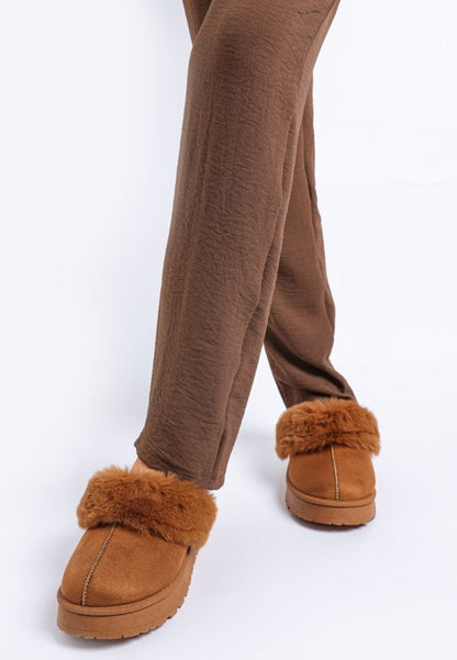 Model wearing Tan Portho Faux Fur Slip Ons showcasing minimal design and soft faux fur.