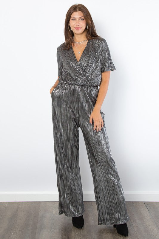 Silver Foil Accent Jumpsuit features a V-neck, short sleeves, pleats, foil details, wide-leg, and pockets.