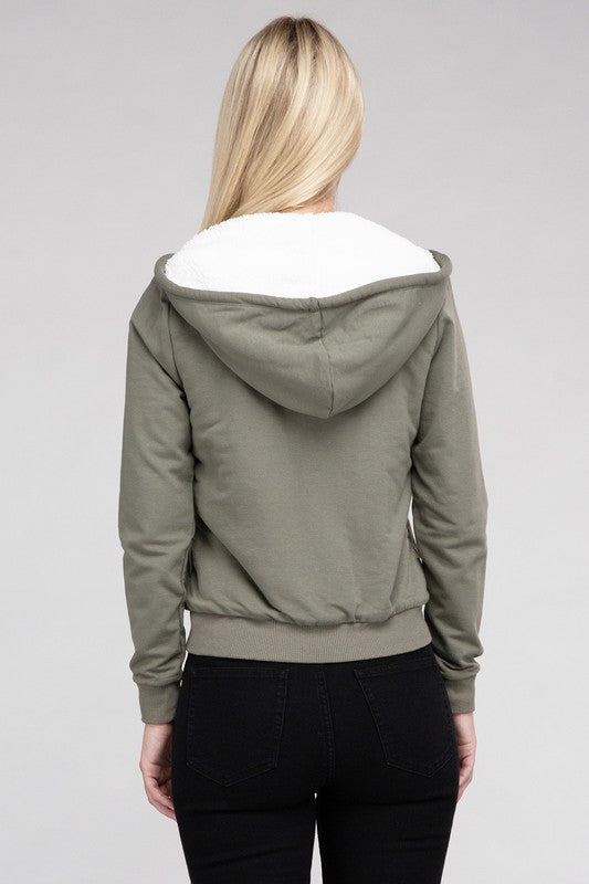 Military green cropped zip-up hoodie with fuzzy trim, pockets, and long sleeves.