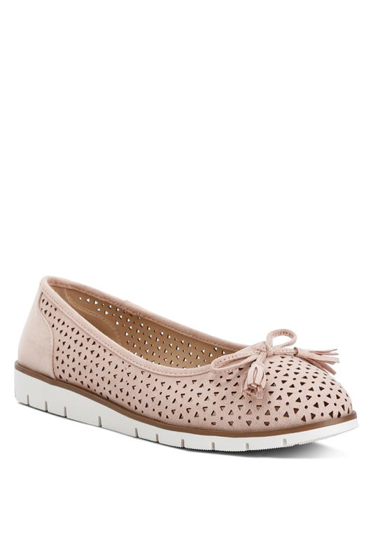 Front angle view of blush Pacer vegan leather ballerina flats featuring perforated design and bow embellishment.