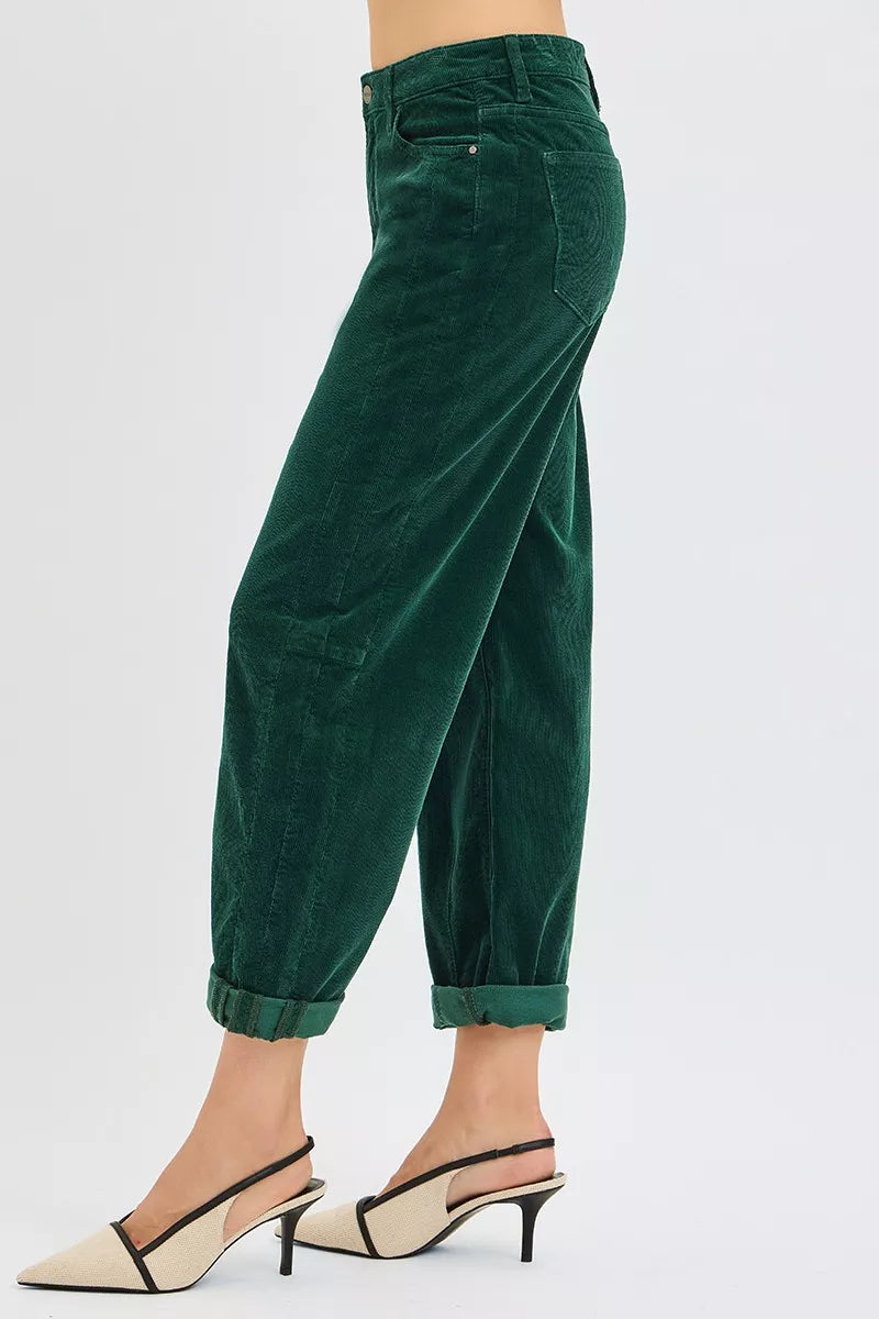 Side angle of Greer High Rise Corduroy Pants showing barrel cut leg and high waist design in textured hunter green fabric.