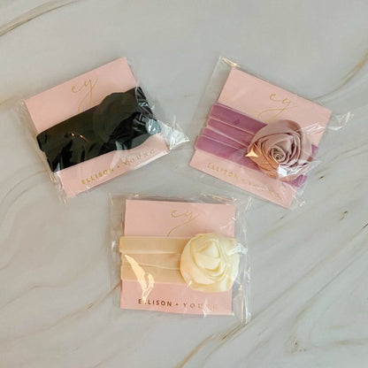 Satin Rose Velvet Sash Necklaces packaged in Ellison + Young branding