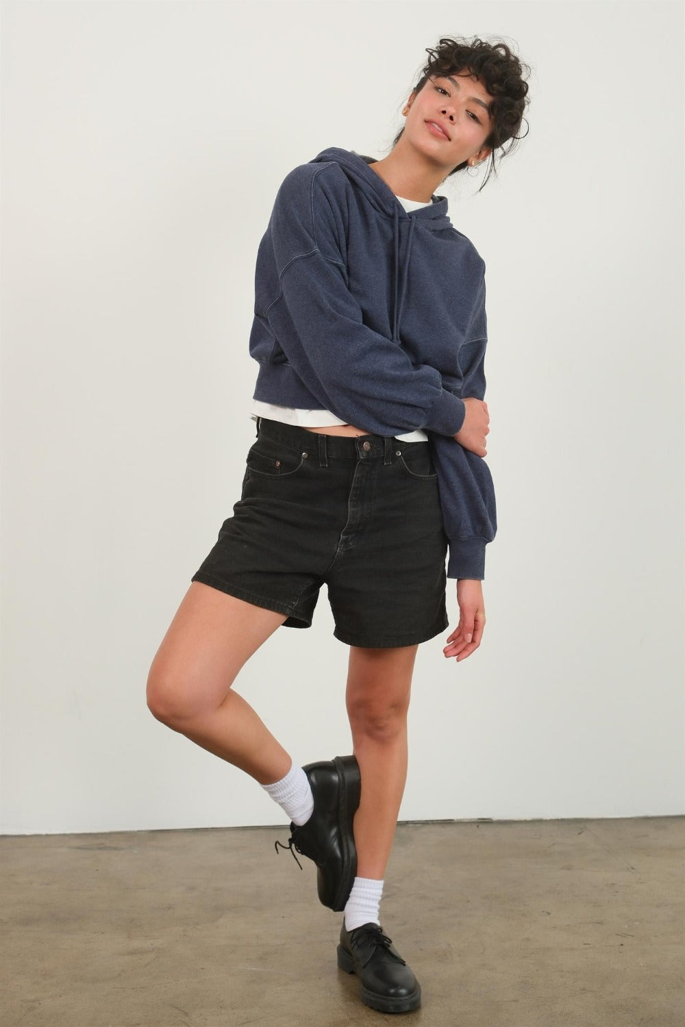 Dark navy cropped hoodie with a hood, drawstring, drop shoulder long sleeves, and a relaxed fit.