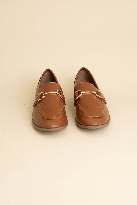 Cognac Horsebit Loafers with guitar motif, featuring horsebit detailing, slip-on style, and flat heel.