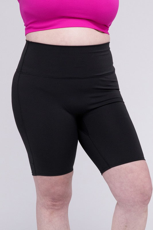 High-rise plus-size athletic biker shorts in black, featuring a fitted silhouette and seamless design for comfort and flexibility.