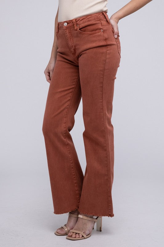 Rust acid-washed straight wide-leg pants featuring a frayed cutoff hem, zip fly closure, and a relaxed fit. Made with stretchy fabric for comfort and a unique vintage-inspired look.