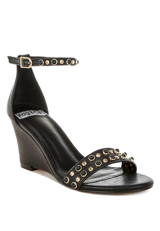 Black leather studded wedge sandals front angle with ankle strap.