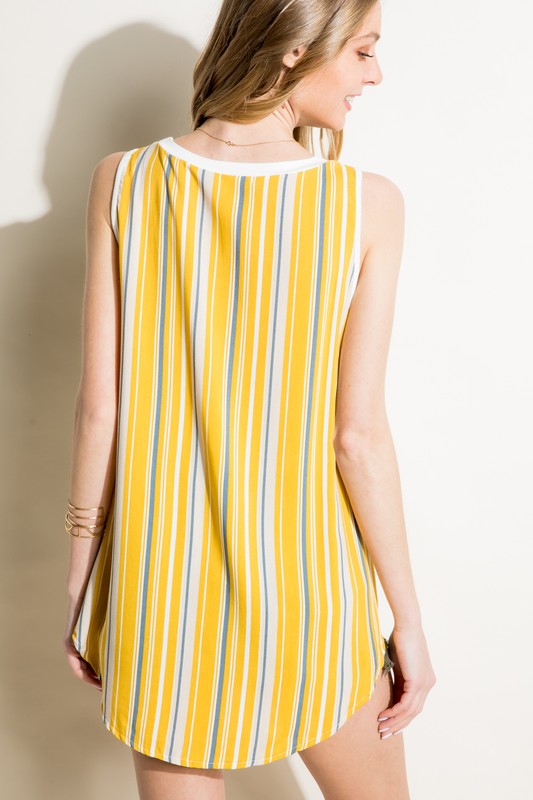 Mustard mixed-pattern tank top with a solid white jersey front, a vibrant striped back, a round neckline, and a sleeveless design, featuring a chest pocket.