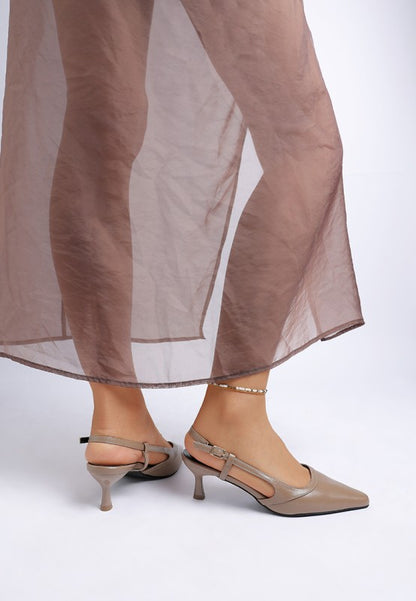 Model wearing Luxton Slingback Pin Buckle Kitten Heels in Taupe paired with sheer dress for a polished, feminine look