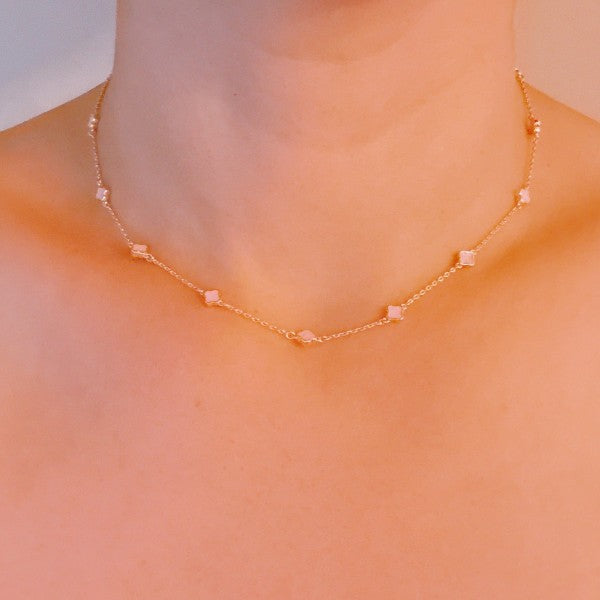 model wearing Petite Colored Clover Necklace in blush pink.