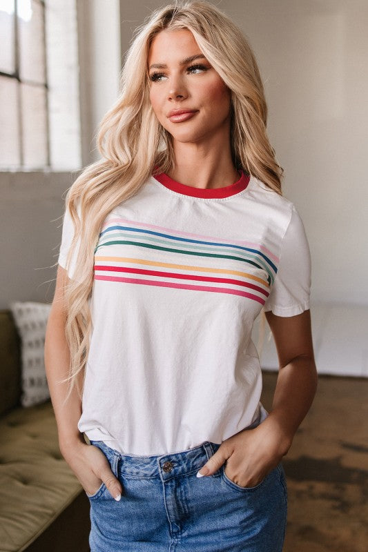 Model wearing Carter Rainbow Stripe Crewneck Top with rainbow stripes on front and soft cotton crew neckline.