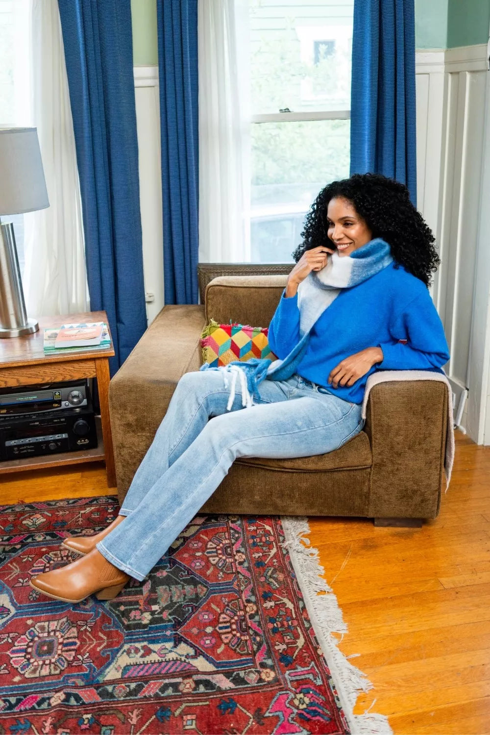 model pairing Misha Thermal Bootcut Jeans with a cozy sweater.