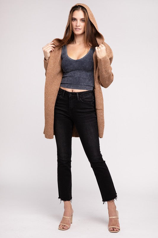 Deep camel sweater cardigan with long sleeves, front pockets, and a hooded neckline. 