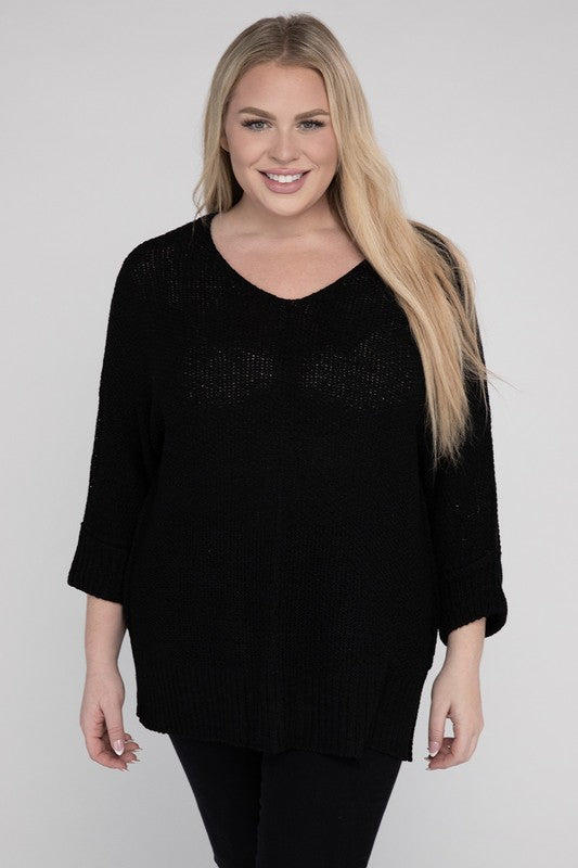 Black plus size crew neck sweater with a loose fit, side slits, long sleeves, and a cozy knit fabric for warmth.