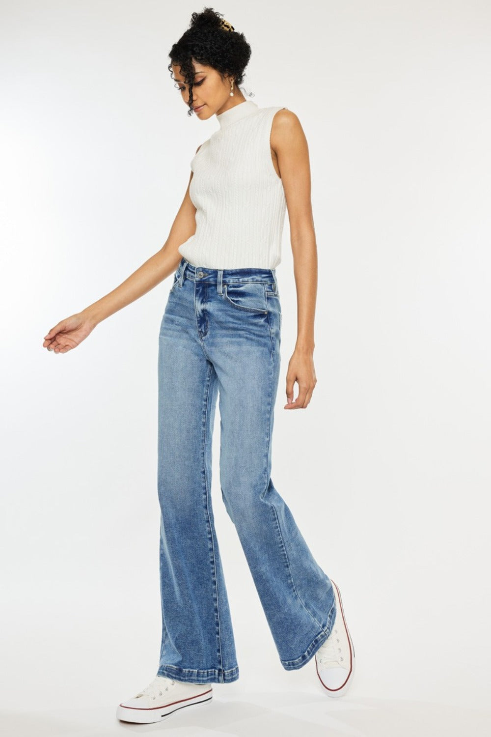 High Rise Wide Leg Jeans in medium wash by Kancan. Slightly stretchy denim with classic 5-pocket design, regular hem, and zipper fly. Versatile wide-leg flare silhouette.