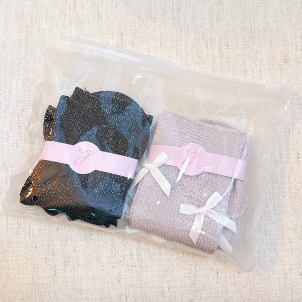 Packaged Shimmer Chic Bow Embellished Socks Set of 2 with pink and black pairs.