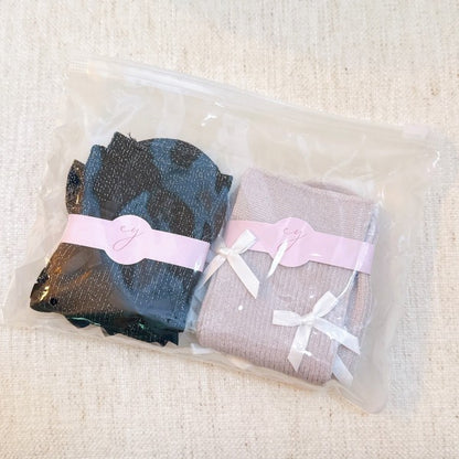 Packaged Shimmer Chic Bow Embellished Socks Set of 2 with pink and black pairs.
