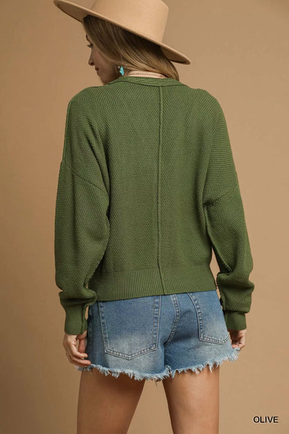 Back view of Uma Olive Cable Knit Cardigan with long sleeves.