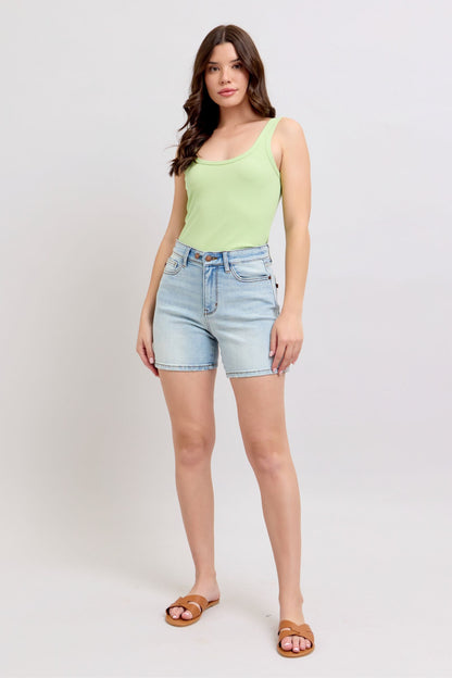 Model wearing Hannah 2-Button Denim Shorts in light wash styled with casual top.