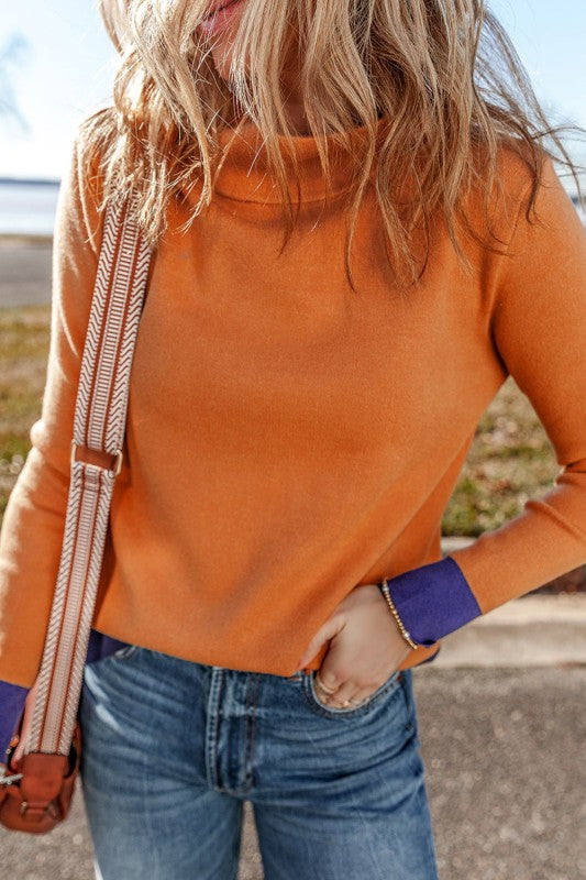 Evangeline Slim Fit Sweater in pumpkin with purple contrast cuffs and waistband