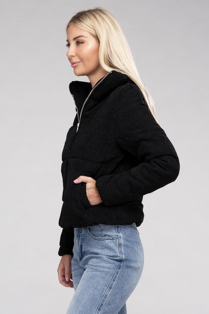 Black corduroy zip-up jacket with a high collar, long sleeves, and a pocket.