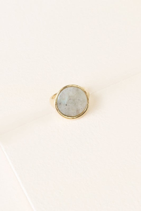 Top view of Ambition Stone Ring in Haze with light gray stone in round gold setting.