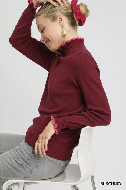Plus side angle: Burgundy ruffle trim sweater with ribbed knit texture.