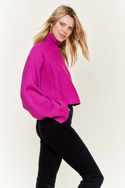 Side view Giada Mock Neck Wide Sleeves Sweater in fuchsia with relaxed hem.