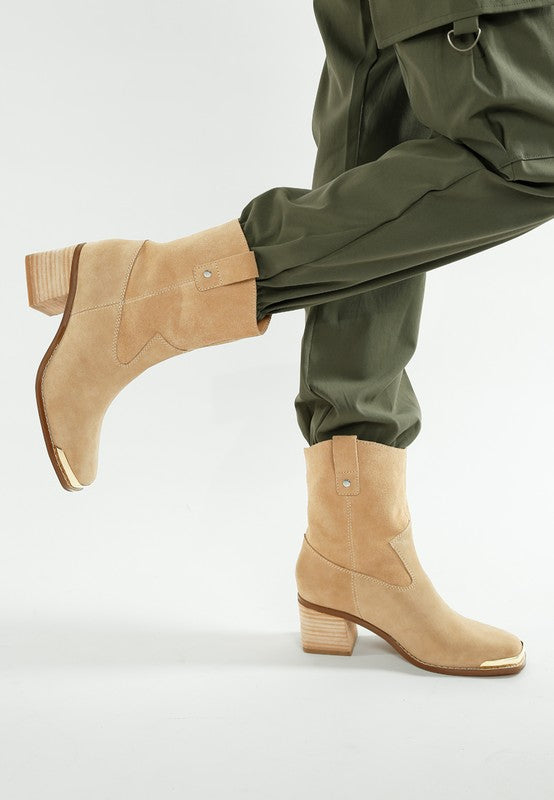 Full-body side view showing beige Emberly boots styled with joggers.