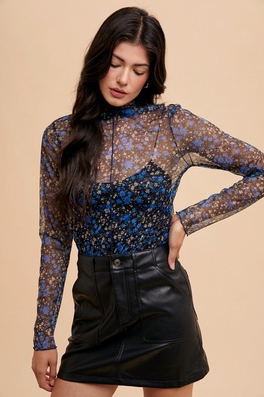 Elodie floral mesh top in black/blue with mock neck and sheer long sleeves, styled for a chic look.