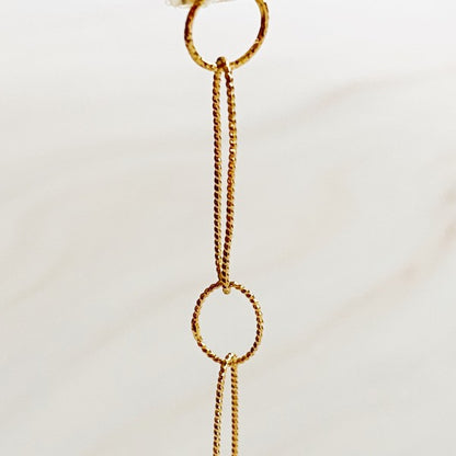 Diamond-cut textured chain links in gold shown close up for shimmer detail