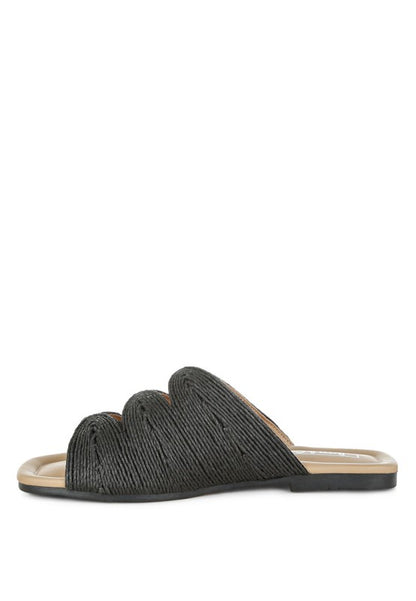 Inside side view of black Daisy Doe raffia flat showing the slip-on design, cushioned insole, and raffia texture.