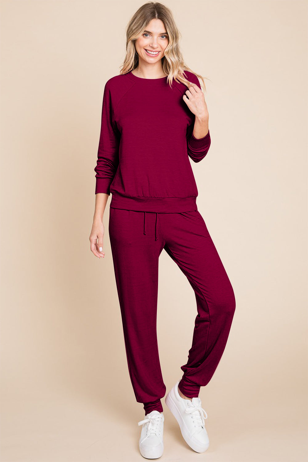 Burgandy lounge set with a round-neck top, raglan sleeves, and drawstring pants.