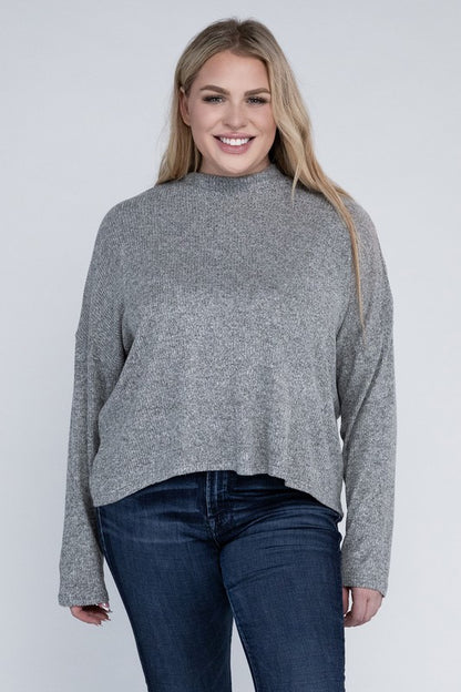 Plus size model wearing Raya Curvy Plus Drop Shoulder Top in heather gray with mock neck, front view.