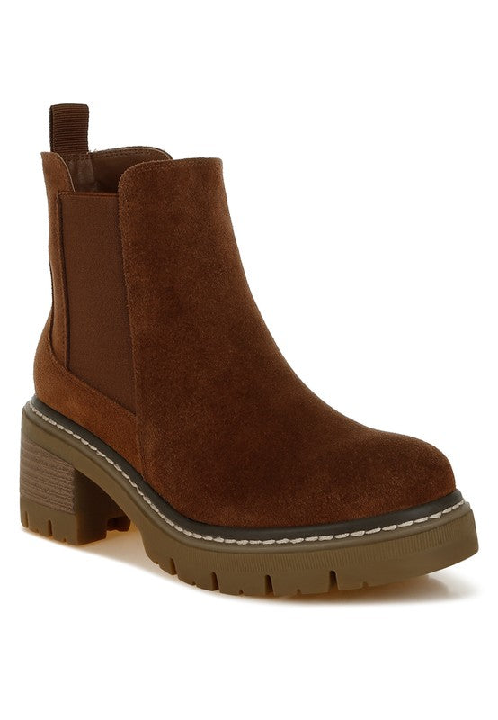 Brown suede Chelsea boots with block heel and round toe.