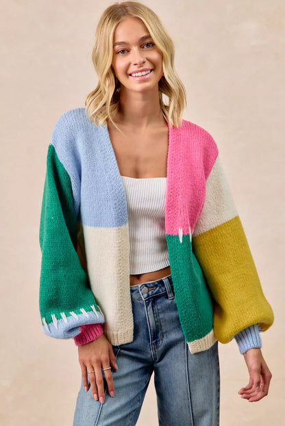 Model wearing Rana Color Block Open Front Sweater Cardigan in hunter green, blue, pink, and yellow.