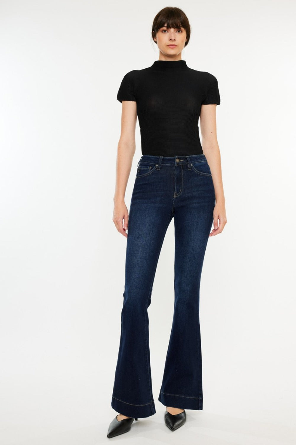 High Rise Slim Flare Jeans by Kancan in dark stone wash, slightly stretchy denim with zip fly. Non-distressed, versatile style for casual or dressed-up looks.