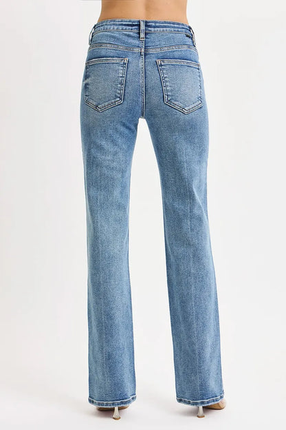 Back view showing pockets, straight leg cut, and flattering high-rise fit of Reese medium wash jeans.