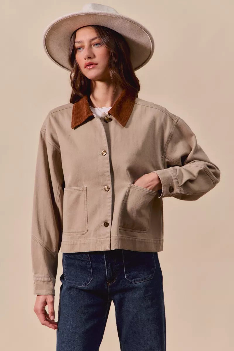 Model styling Suri Cotton Twill Cropped Barn Jacket over jeans for casual chic look.