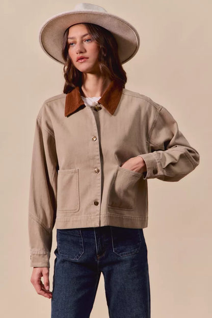 Model styling Suri Cotton Twill Cropped Barn Jacket over jeans for casual chic look.