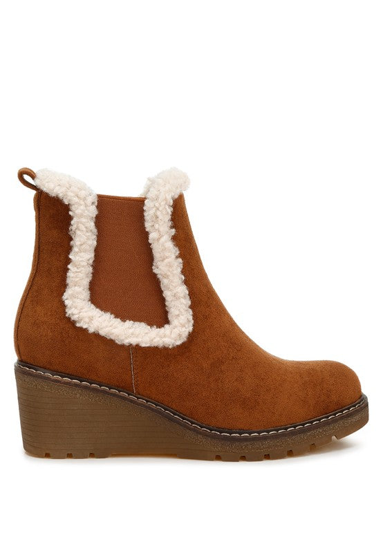 Side view of tan Thunderhoof Chelsea Boots showing elasticated gussets and fur trim.