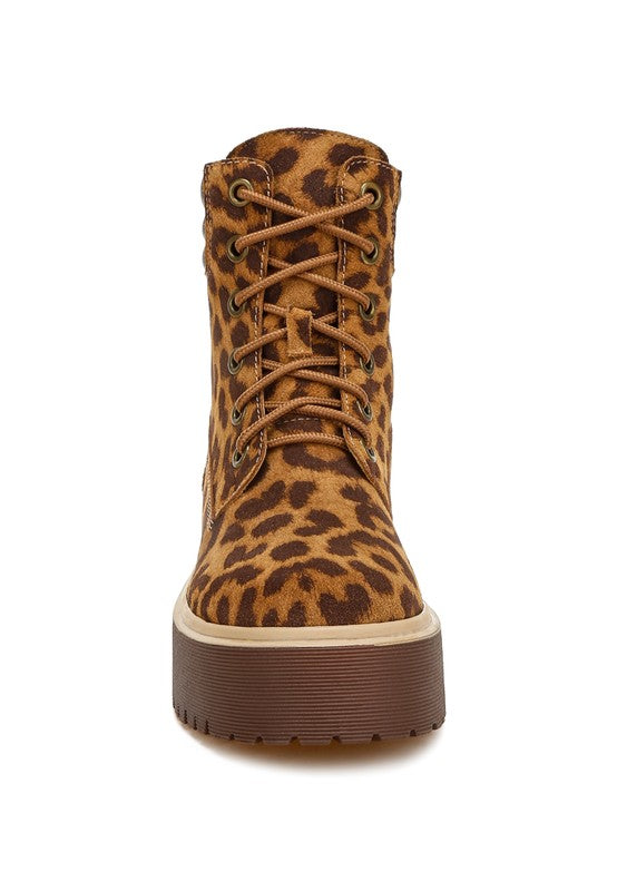 Leopard print high-ankle suede boots with a quilted collar, lace-up design, round closed toe, and low block platform heel. Features cushioned insoles and a durable lug sole.