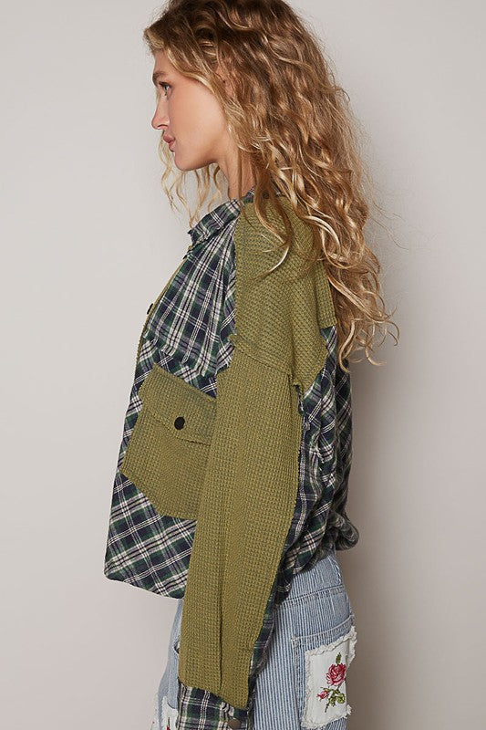 A women's button-down shirt featuring an olive green waffle knit with contrasting plaid accents, long sleeves, and a relaxed fit.