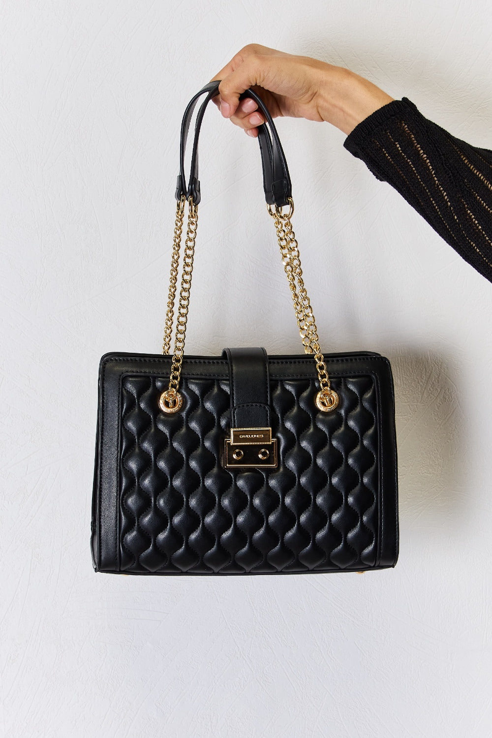 Black small quilted PU leather handbag in a stylish design, featuring a sleek appearance and multiple compartments.