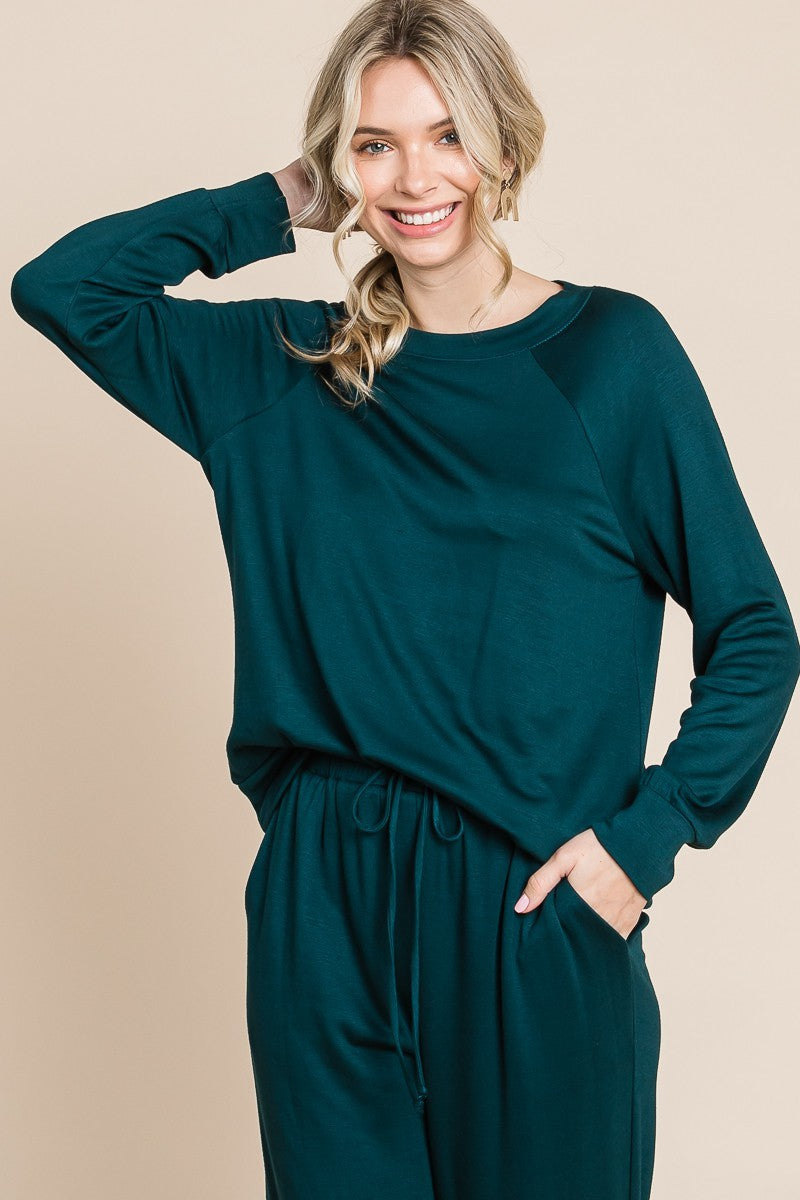 Hunter green lounge set with a round-neck top, raglan sleeves, and drawstring pants.