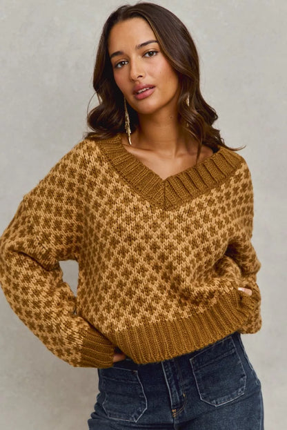 Model wearing Chloe caramel knit V-neck sweater with long sleeves and ribbed finish, casual styling.