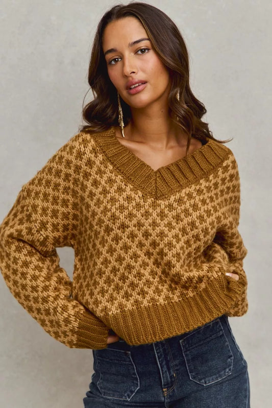Model wearing Chloe caramel knit V-neck sweater with long sleeves and ribbed finish, casual styling.