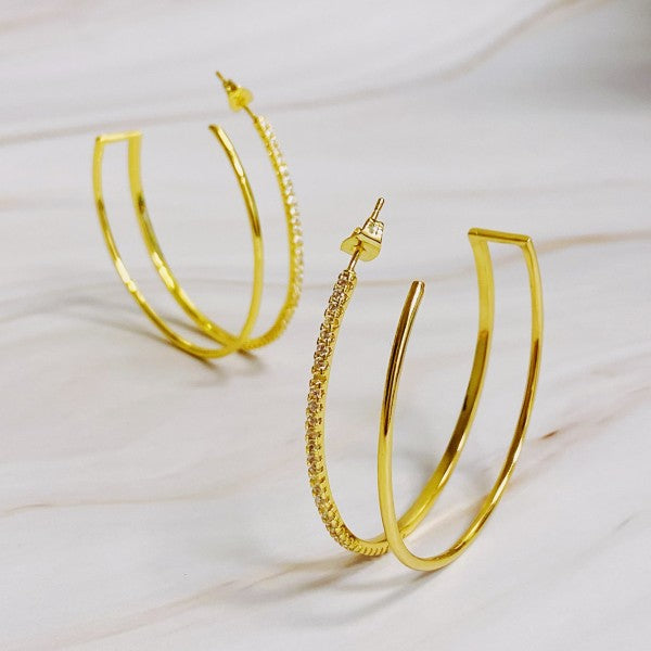 Double Open Top Hoop Earrings in gold with cubic zirconia sparkle displayed on marble background